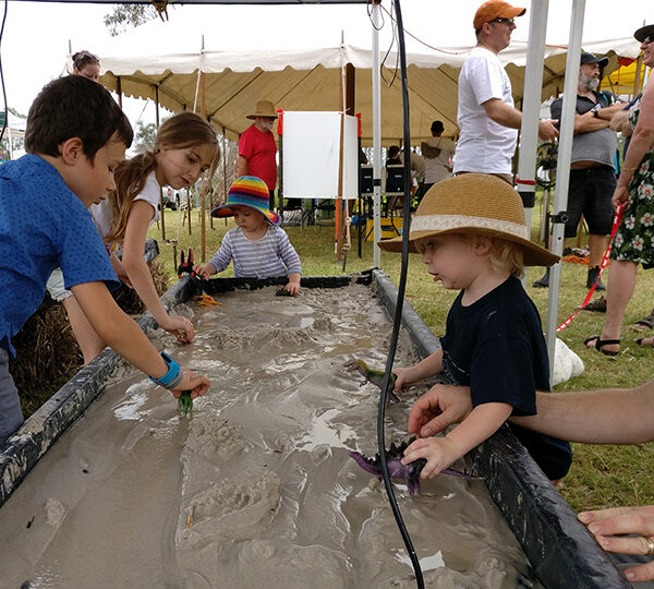 Children playing with the model creek at Design Your Creek Week